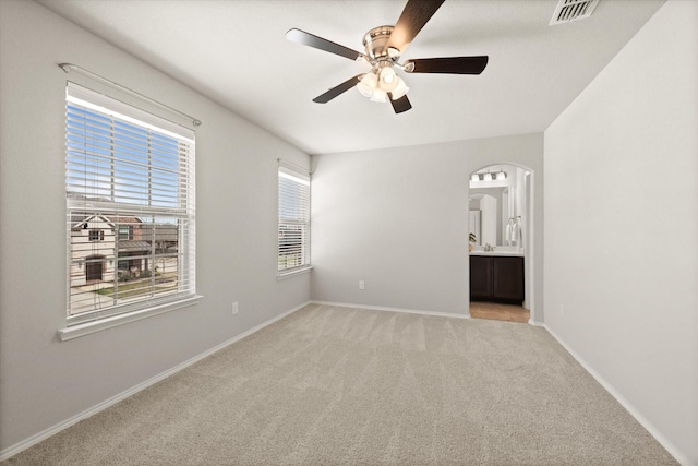 empty room with light colored carpet and ceiling fan