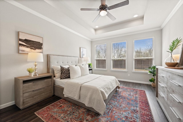 bedroom with crown molding, ceiling fan, a tray ceiling, and dark hardwood / wood-style flooring