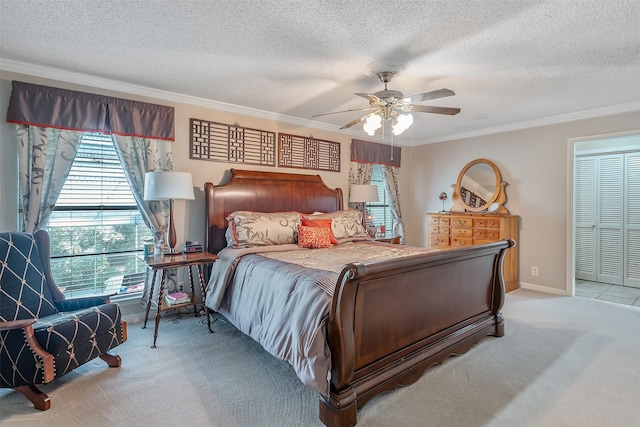 bedroom featuring ceiling fan, a textured ceiling, light carpet, and a closet