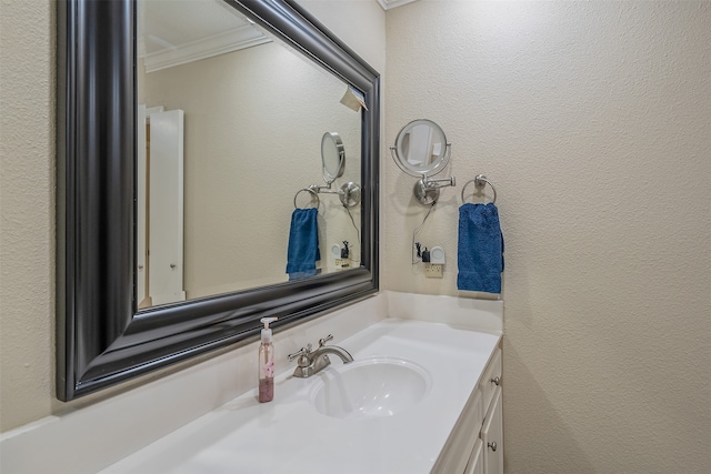 bathroom featuring crown molding and vanity