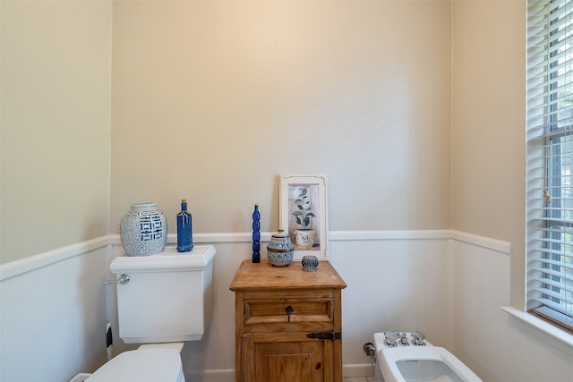 bathroom with a bidet and toilet