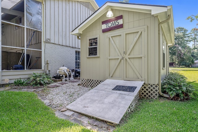 view of outbuilding with a lawn