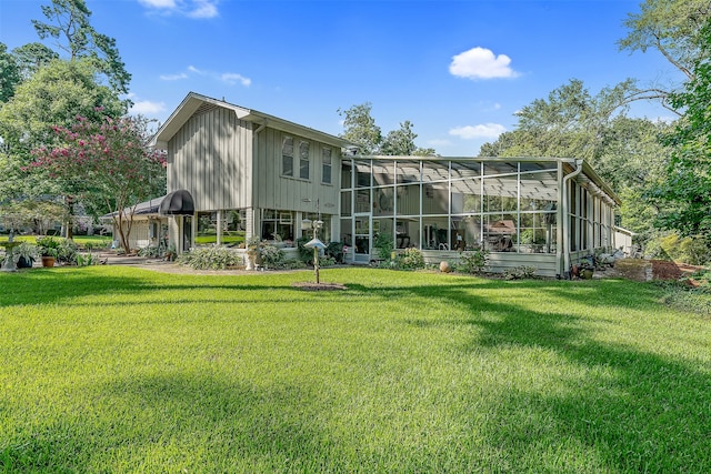 rear view of property featuring a yard