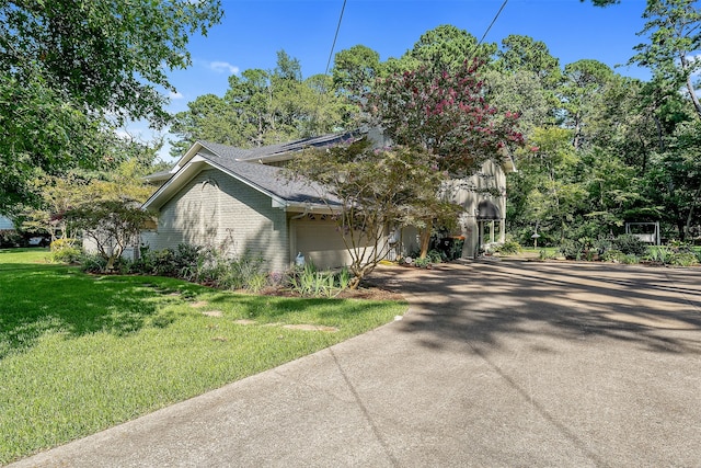 view of front of house with a front lawn and a garage