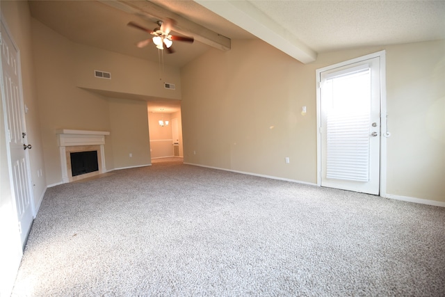 unfurnished living room with a textured ceiling, a high end fireplace, ceiling fan, carpet floors, and beamed ceiling