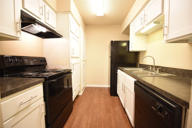 kitchen featuring a textured ceiling, light hardwood / wood-style floors, white cabinetry, black appliances, and sink