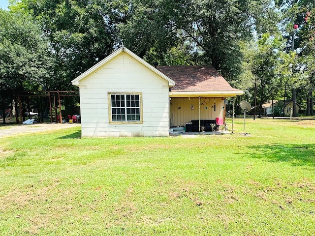 view of outdoor structure with a lawn