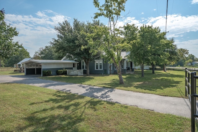 view of front of home with a front lawn and a carport