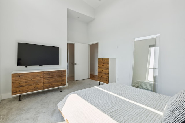 carpeted bedroom featuring a high ceiling