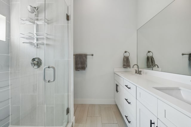 bathroom with double vanity, an enclosed shower, and tile patterned floors