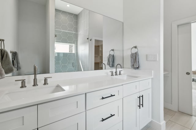 bathroom with tile patterned floors, walk in shower, and double vanity