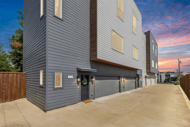 property exterior at dusk with a garage