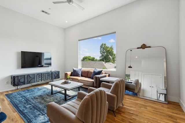 living room with ceiling fan and light hardwood / wood-style floors