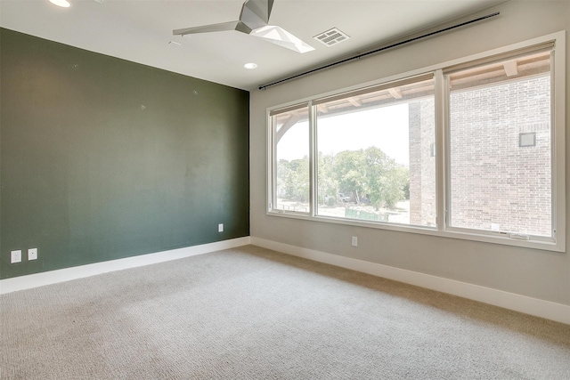 carpeted spare room with ceiling fan