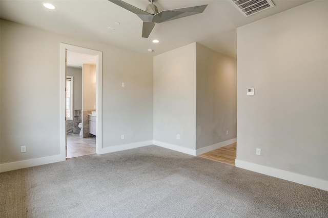 unfurnished room featuring ceiling fan and light colored carpet