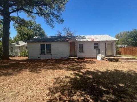 back of house with fence