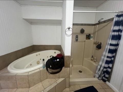 bathroom featuring a stall shower, a whirlpool tub, and tile patterned floors