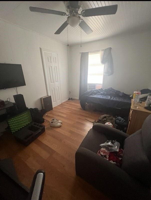 bedroom with a ceiling fan and wood finished floors