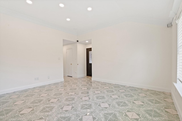 empty room featuring lofted ceiling and ornamental molding