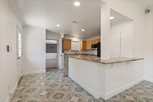 kitchen featuring kitchen peninsula, a kitchen bar, black refrigerator with ice dispenser, ornamental molding, and stone countertops