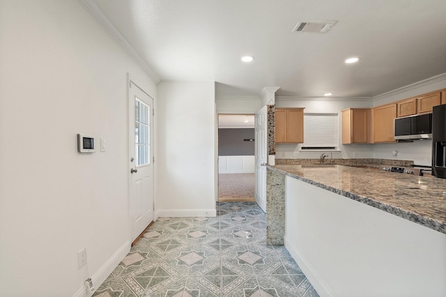 kitchen featuring light tile patterned floors, sink, stone counters, and ornamental molding