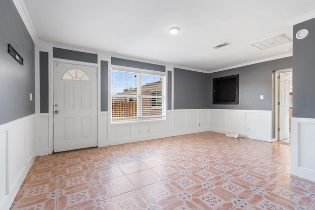 tiled foyer entrance featuring ornamental molding