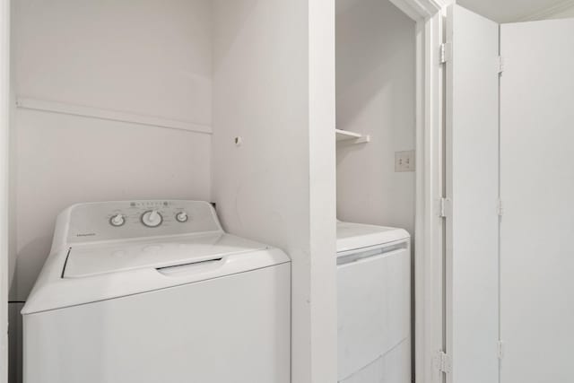 clothes washing area featuring independent washer and dryer