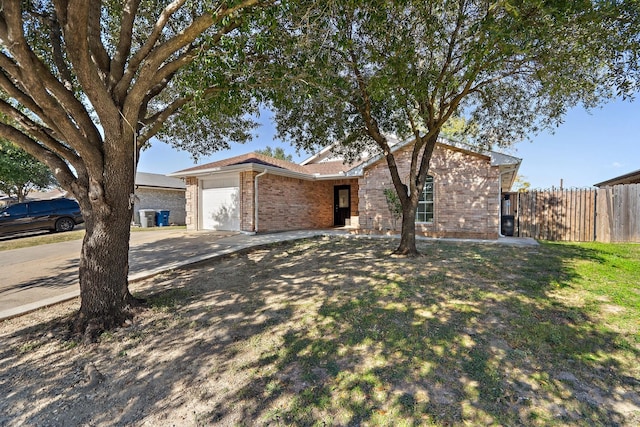 single story home featuring a garage and a front yard