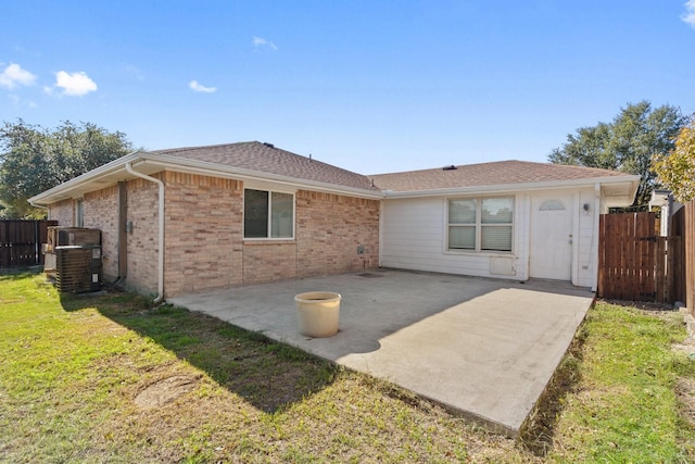 back of house featuring a yard and a patio