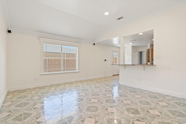 spare room with crown molding and lofted ceiling