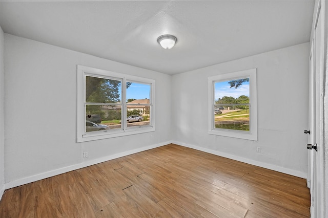 unfurnished room with light wood-type flooring