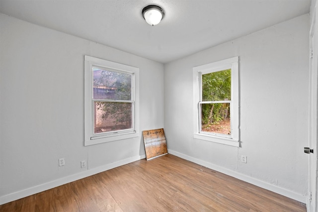 unfurnished room with light hardwood / wood-style floors