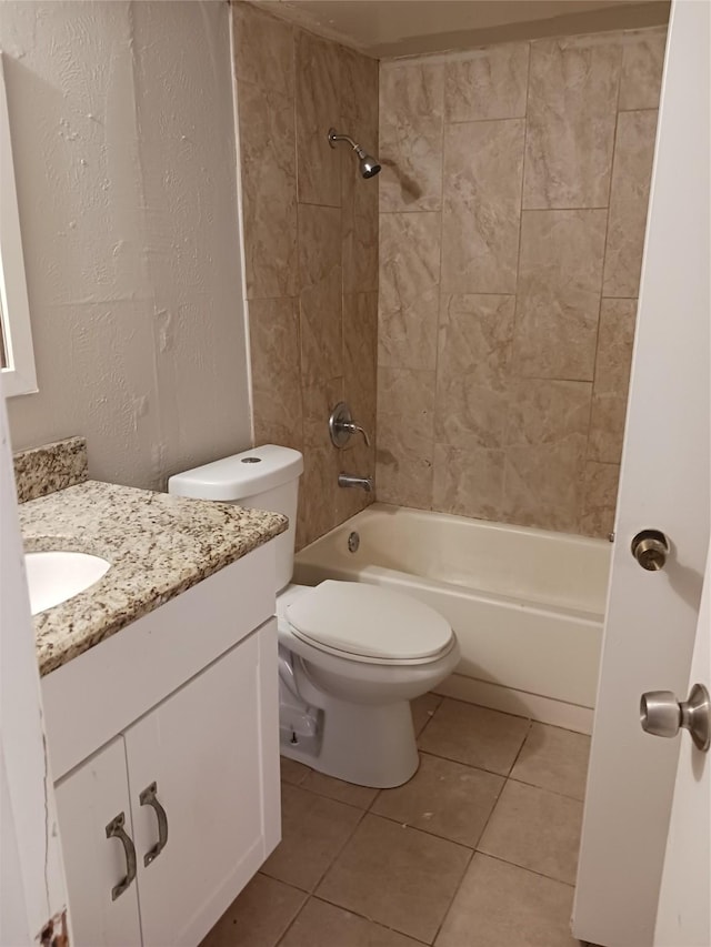 full bathroom with tiled shower / bath, vanity, toilet, and tile patterned flooring