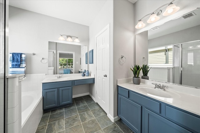 bathroom with vanity and independent shower and bath