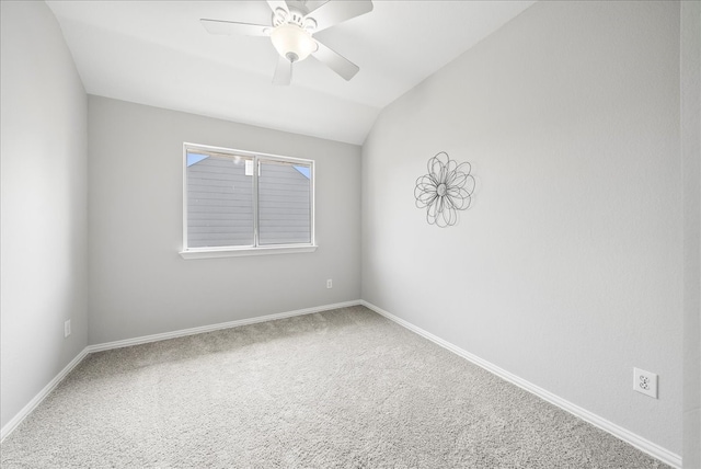 spare room with vaulted ceiling, ceiling fan, and carpet flooring