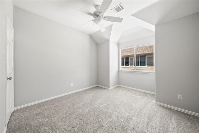 unfurnished room with light carpet, vaulted ceiling, and ceiling fan