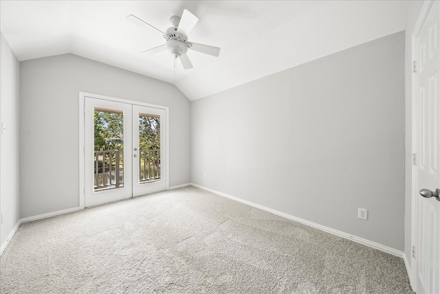 carpeted spare room with ceiling fan and vaulted ceiling