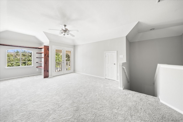 unfurnished living room featuring ceiling fan and carpet floors