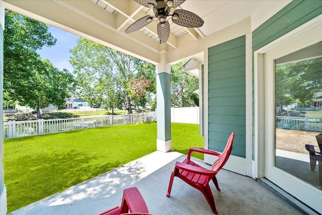 view of patio / terrace with a water view and ceiling fan