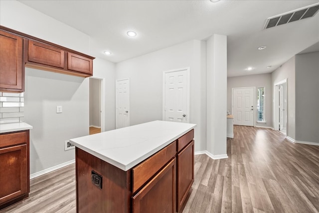 kitchen with light wood-type flooring and a center island