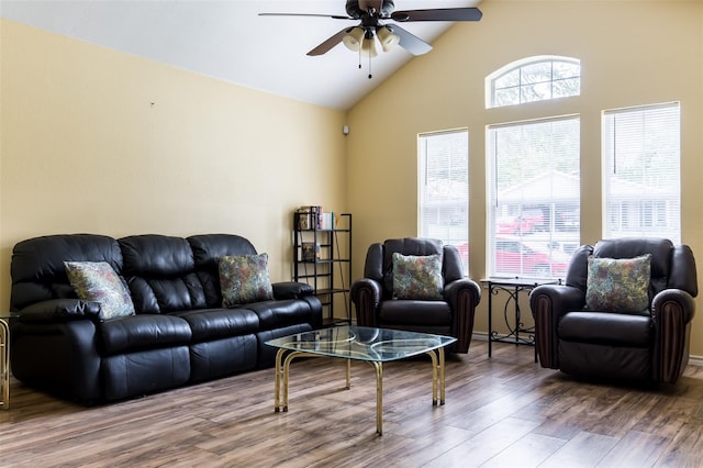 living room with ceiling fan, lofted ceiling, and hardwood / wood-style flooring