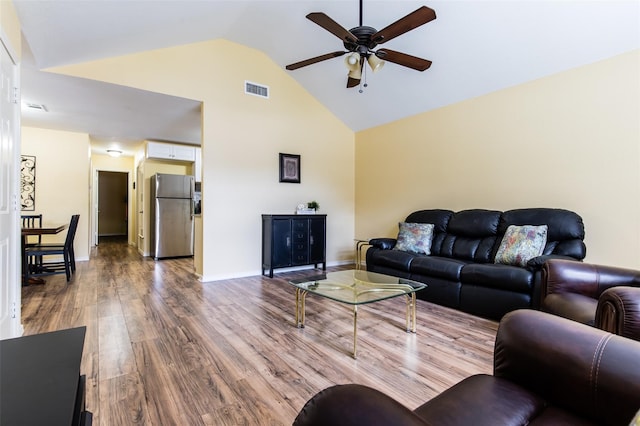 living room with ceiling fan, high vaulted ceiling, and hardwood / wood-style flooring