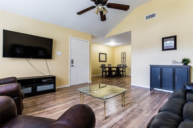 living room featuring high vaulted ceiling, hardwood / wood-style floors, and ceiling fan