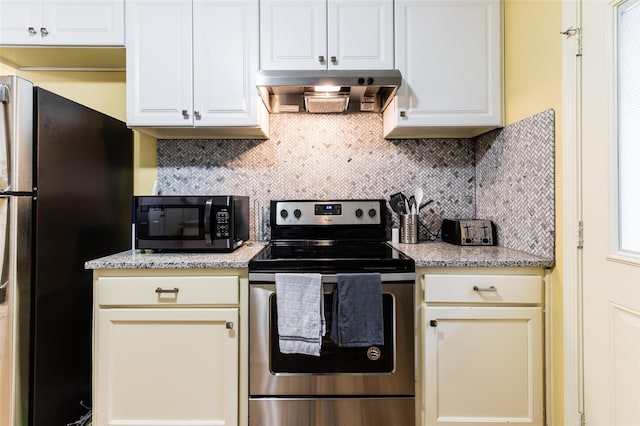 kitchen with appliances with stainless steel finishes, light stone countertops, tasteful backsplash, and wall chimney exhaust hood