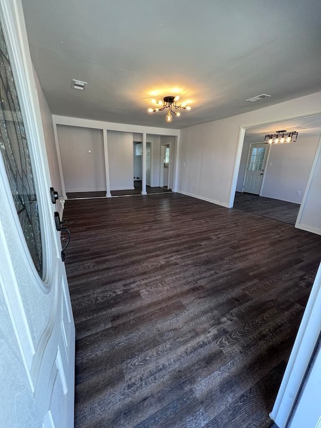 spare room featuring dark hardwood / wood-style flooring