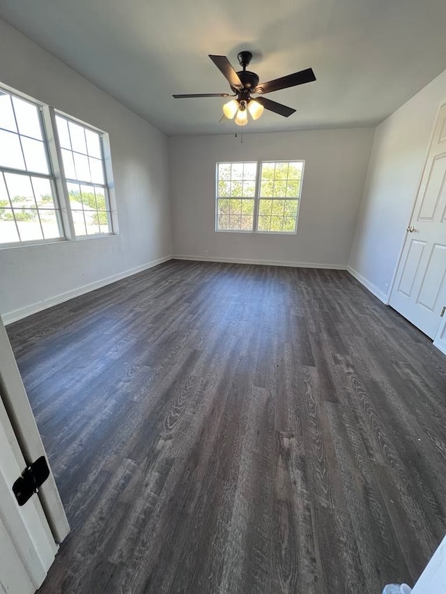 unfurnished room featuring ceiling fan and dark hardwood / wood-style flooring