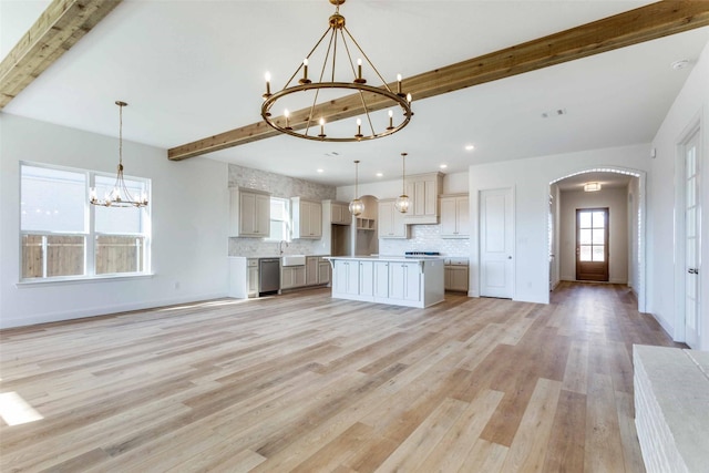 kitchen with beam ceiling, dishwasher, decorative backsplash, and an inviting chandelier