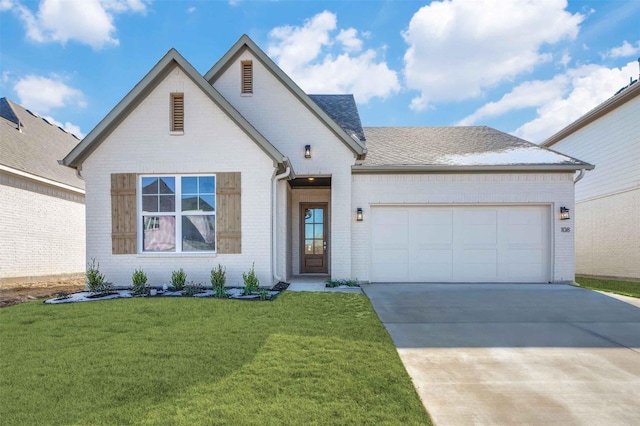 view of front of house featuring brick siding, a shingled roof, concrete driveway, an attached garage, and a front yard