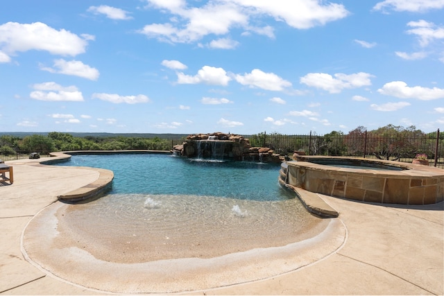 view of pool with pool water feature and an in ground hot tub