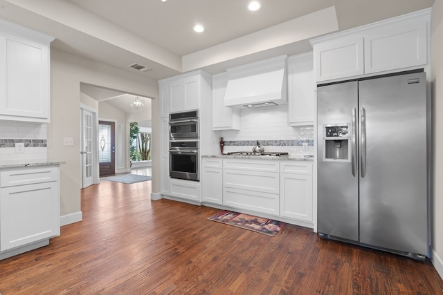 kitchen featuring appliances with stainless steel finishes, backsplash, and dark hardwood / wood-style floors